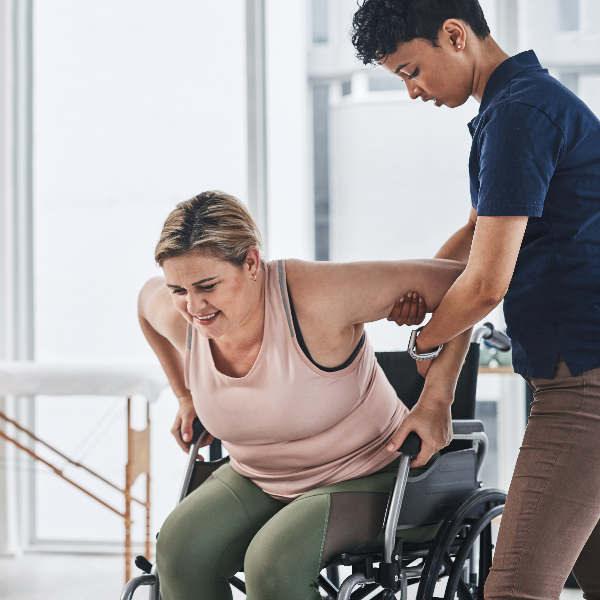 Physiotherapist assisting a patient with upper body rehabilitation