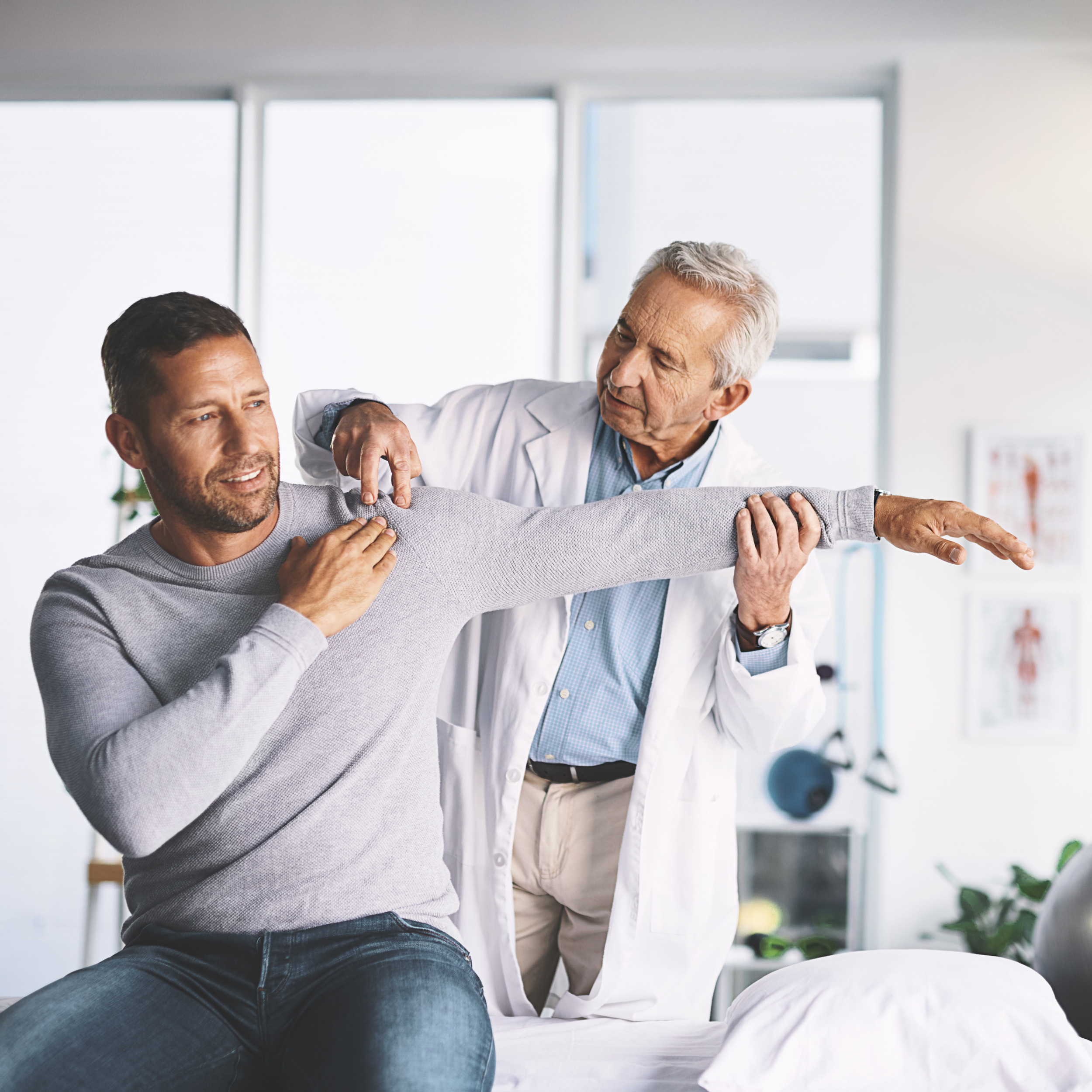 Physiotherapist assisting a patient with shoulder movement